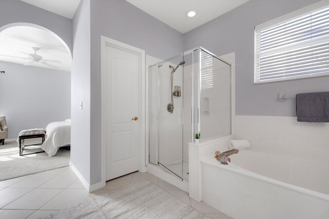 bathroom with tile patterned flooring, separate shower and tub, and ceiling fan