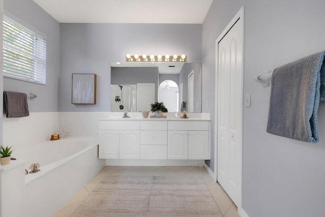 bathroom with tile patterned flooring, vanity, and independent shower and bath