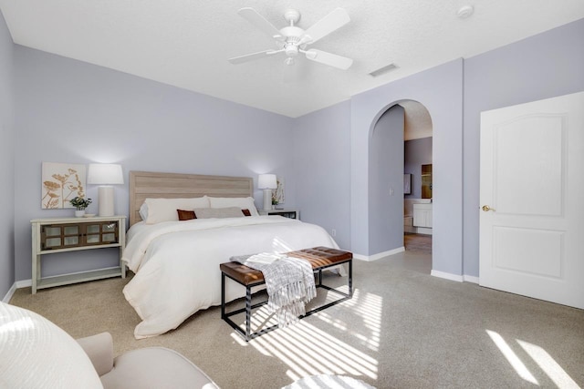 carpeted bedroom featuring ceiling fan and a textured ceiling