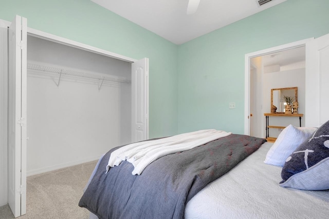 carpeted bedroom with ceiling fan and a closet