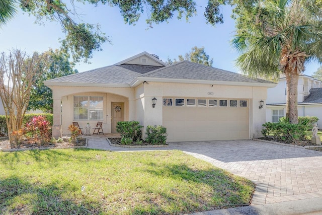 view of front facade with a garage and a front yard