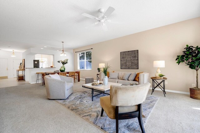 living room featuring light carpet and ceiling fan