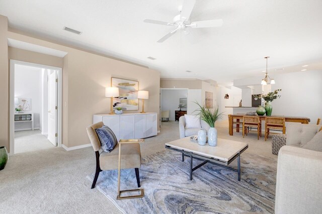 living room with light colored carpet and ceiling fan