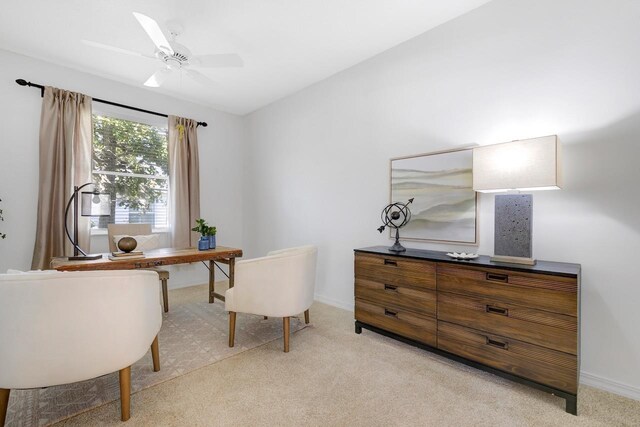 home office with light carpet and ceiling fan