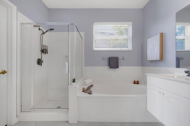 bathroom featuring tile patterned floors, vanity, separate shower and tub, and a wealth of natural light