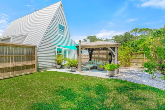 rear view of house with a patio, a fenced backyard, an outdoor hangout area, a yard, and a gazebo