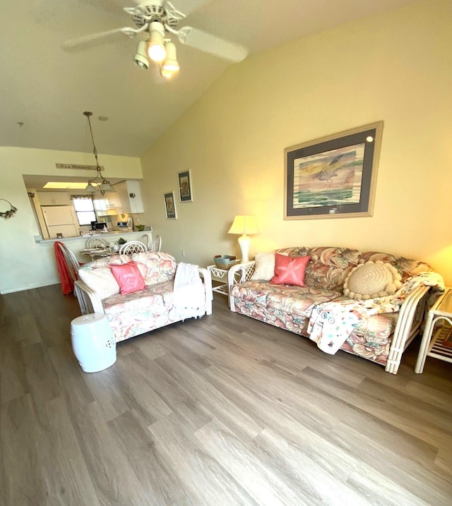 living room with hardwood / wood-style flooring, ceiling fan, and lofted ceiling