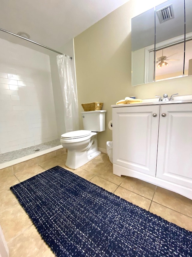 bathroom featuring tile patterned floors, vanity, toilet, and walk in shower