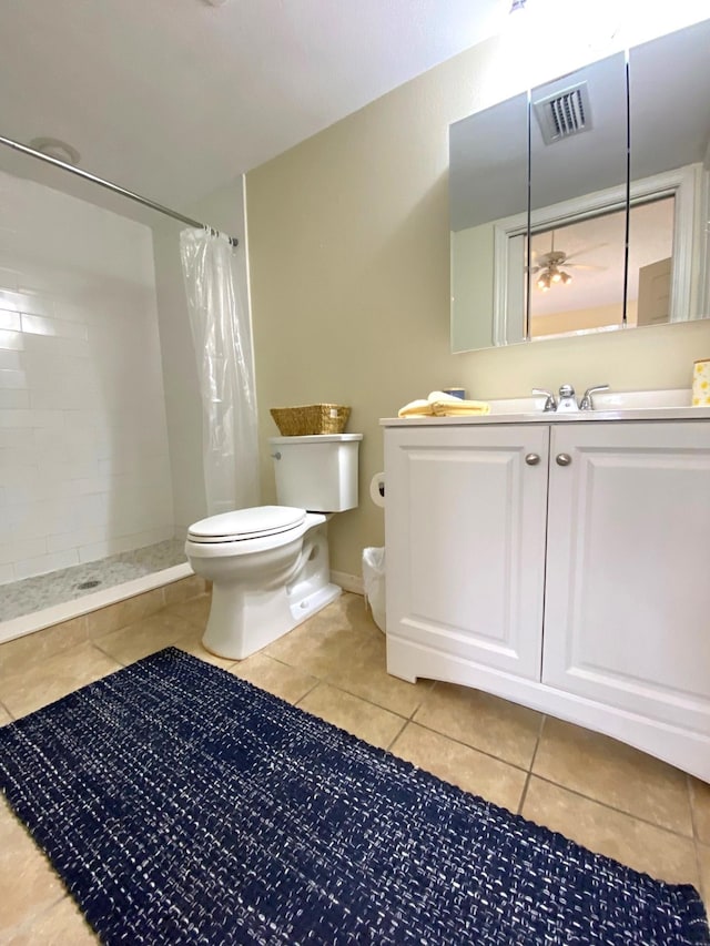 bathroom with tile patterned floors, ceiling fan, a shower with shower curtain, and toilet