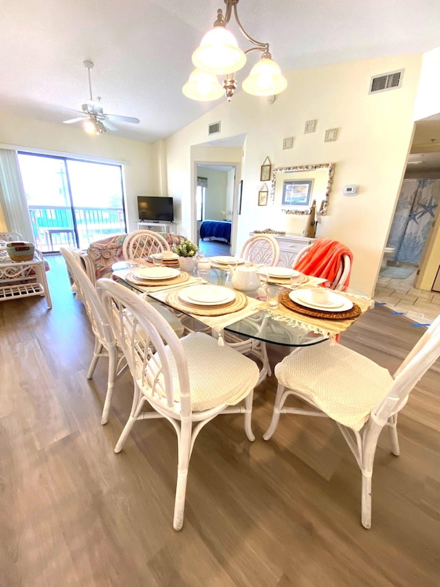 dining area featuring ceiling fan, vaulted ceiling, and hardwood / wood-style flooring