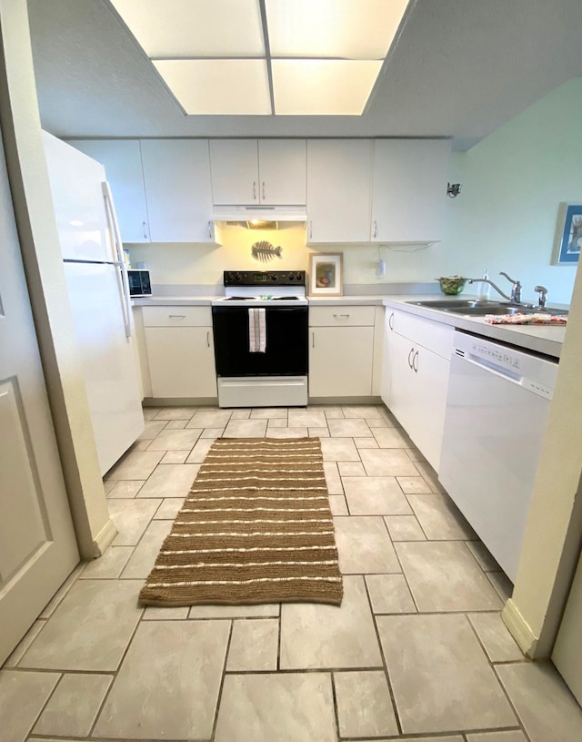 kitchen with white cabinets, white appliances, and sink