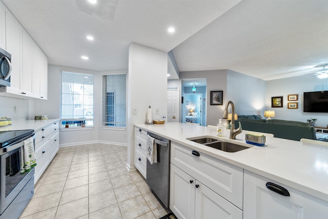 208 Augusta Cir, Saint Augustine, FL 32086 - kitchen with stainless steel appliances, open floor plan, light countertops, recessed lighting, and white cabinets