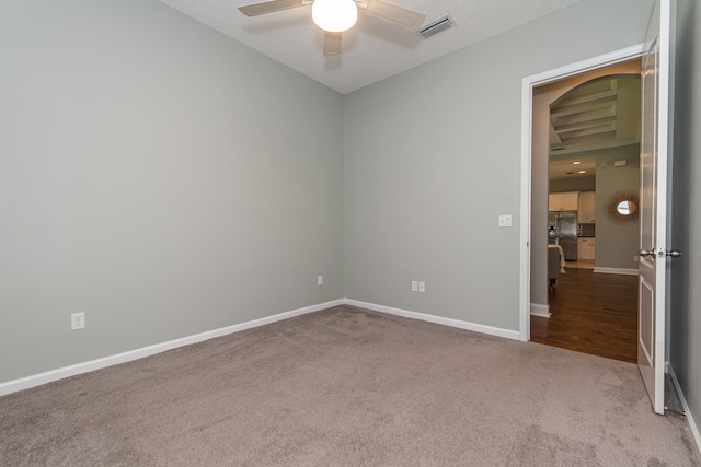 carpeted empty room with ceiling fan