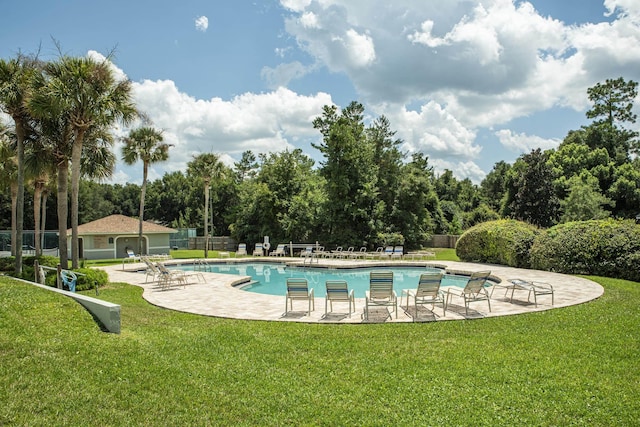 view of pool with a yard and a patio