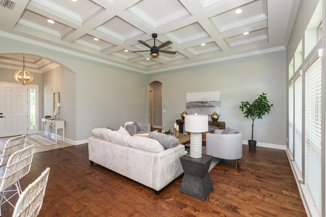 living room featuring ceiling fan with notable chandelier, dark hardwood / wood-style flooring, ornamental molding, and coffered ceiling