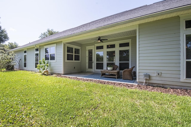 rear view of property with a patio, ceiling fan, and a lawn