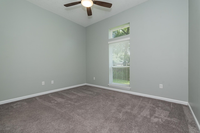 carpeted empty room featuring ceiling fan and a textured ceiling