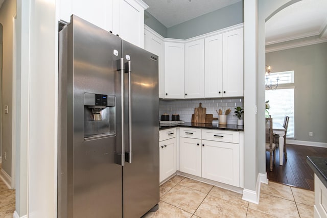 kitchen with white cabinets, light hardwood / wood-style floors, and stainless steel fridge with ice dispenser