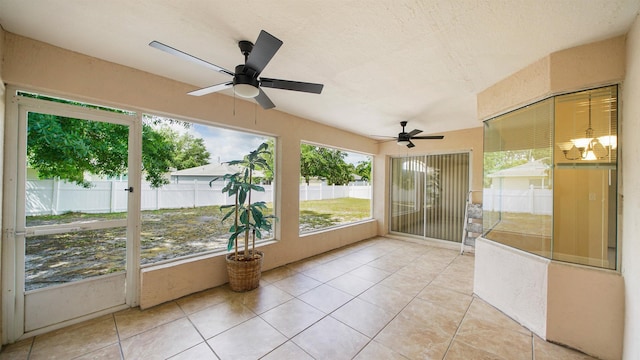 unfurnished sunroom with a ceiling fan