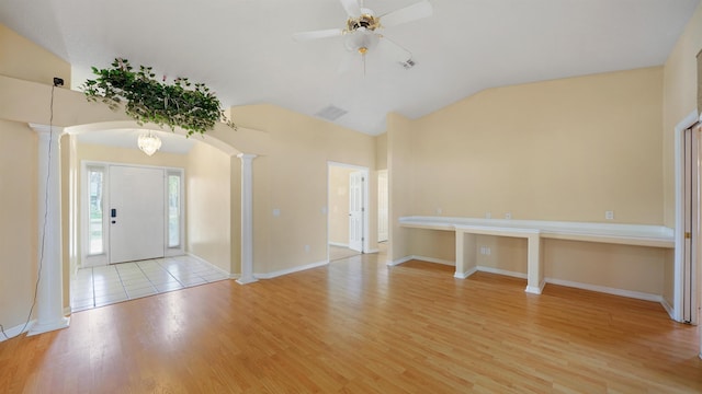 entryway with ceiling fan, decorative columns, lofted ceiling, and light wood finished floors
