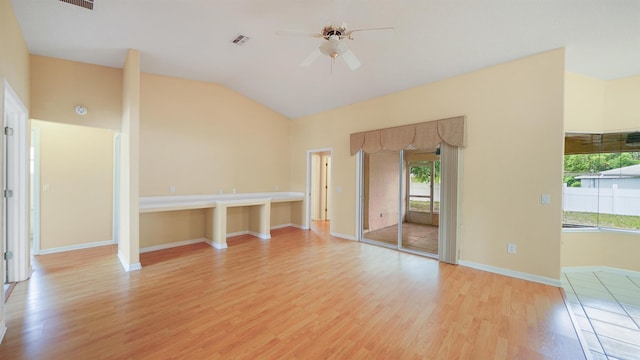 unfurnished room with visible vents, light wood-style flooring, ceiling fan, and a wealth of natural light