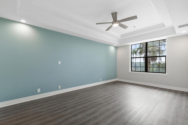 701 Market St Unit 304, Saint Augustine, FL 32095 - spare room featuring a tray ceiling, ceiling fan, dark wood-style flooring, recessed lighting, and baseboards