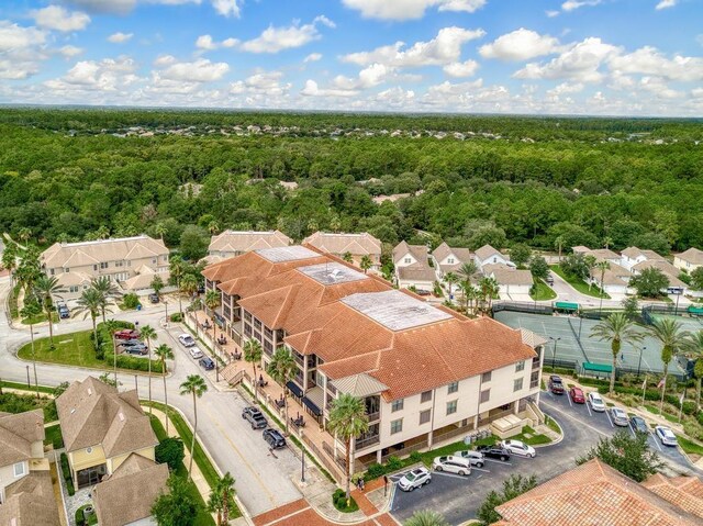 drone / aerial view featuring a residential view and a view of trees