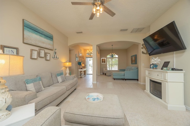 984 Windward Way, Saint Augustine, FL 32080 - living room featuring arched walkways, a chandelier, ceiling fan, and a textured ceiling