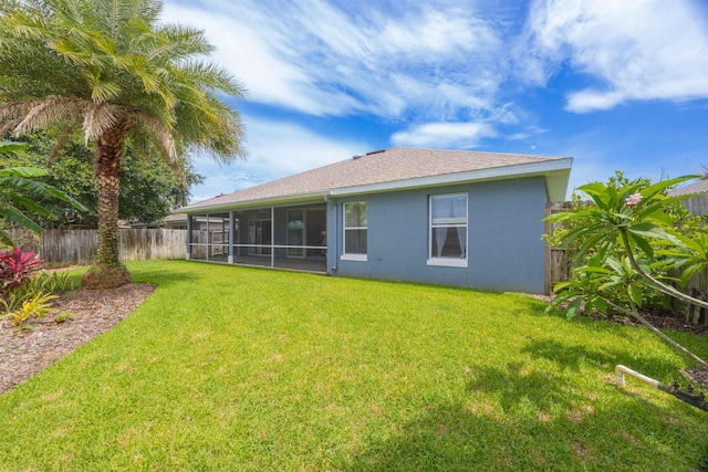 984 Windward Way, Saint Augustine, FL 32080 - back of house with a sunroom, a fenced backyard, stucco siding, and a shingled roof