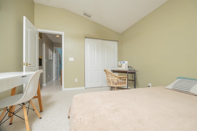 984 Windward Way, Saint Augustine, FL 32080 - bedroom with vaulted ceiling, an office area, a closet, light carpet, and a textured ceiling