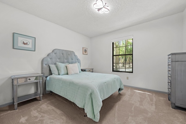 bedroom featuring carpet and a textured ceiling