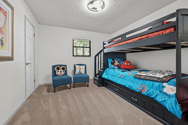 carpeted bedroom with a textured ceiling