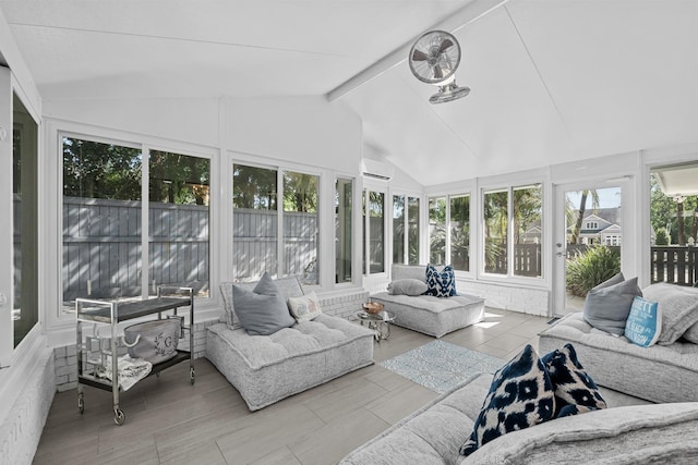 sunroom featuring a wall mounted AC, plenty of natural light, and lofted ceiling with beams