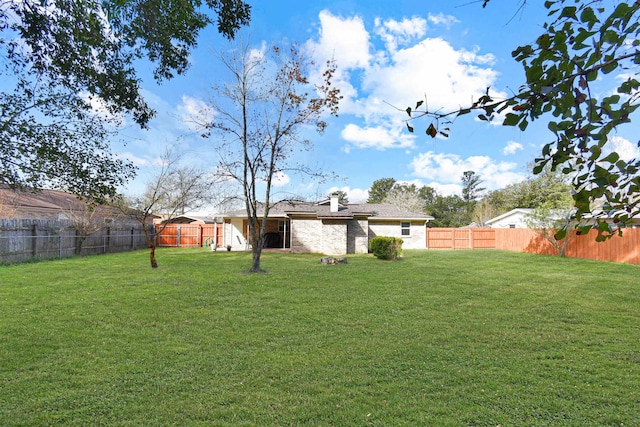 view of yard with a fenced backyard