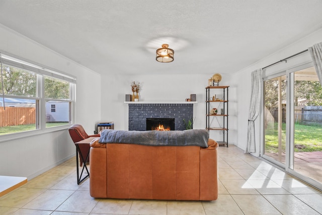 living room with a healthy amount of sunlight, light tile patterned floors, a fireplace, and baseboards