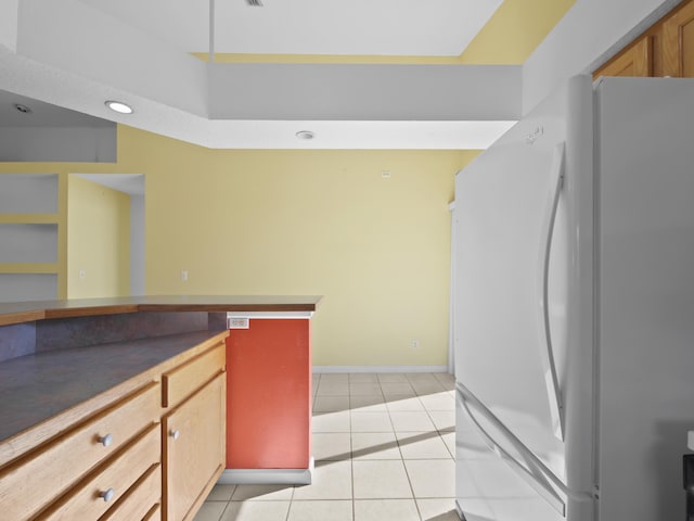 kitchen featuring white fridge and light tile patterned floors