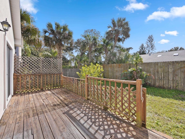 wooden deck with a lawn