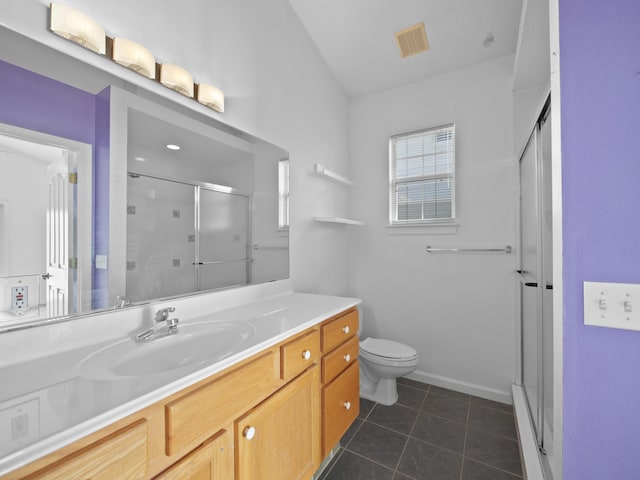 bathroom with an enclosed shower, vanity, tile patterned floors, and toilet