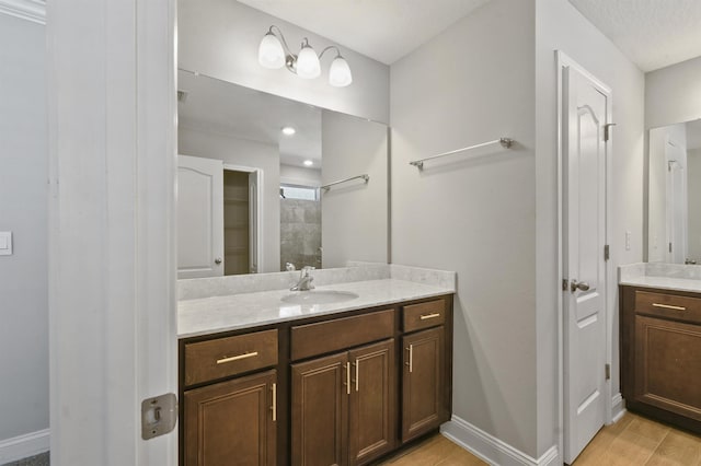 181 Narvarez Ave, Saint Augustine, FL 32084 - bathroom with two vanities, baseboards, a sink, and a tile shower