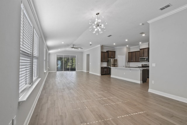 181 Narvarez Ave, Saint Augustine, FL 32084 - unfurnished living room with baseboards, vaulted ceiling, visible vents, and ornamental molding