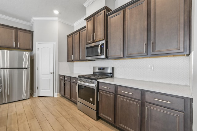 181 Narvarez Ave, Saint Augustine, FL 32084 - kitchen featuring light countertops, dark brown cabinets, appliances with stainless steel finishes, and ornamental molding