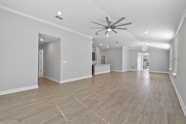 181 Narvarez Ave, Saint Augustine, FL 32084 - unfurnished living room featuring visible vents, ornamental molding, and ceiling fan with notable chandelier