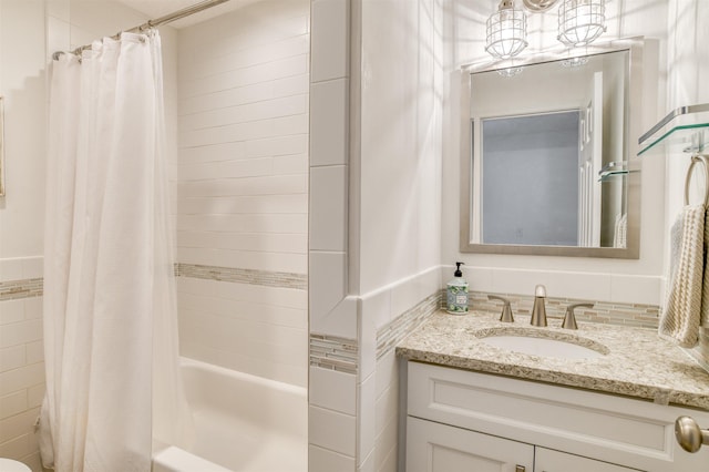 bathroom featuring vanity, shower / bath combination with curtain, and tile walls