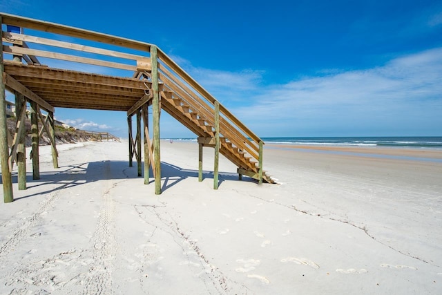 exterior space featuring a beach view and a water view