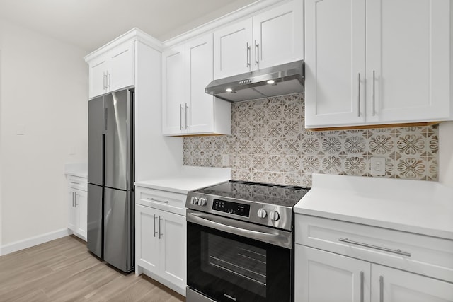 kitchen with tasteful backsplash, light hardwood / wood-style flooring, white cabinets, and appliances with stainless steel finishes