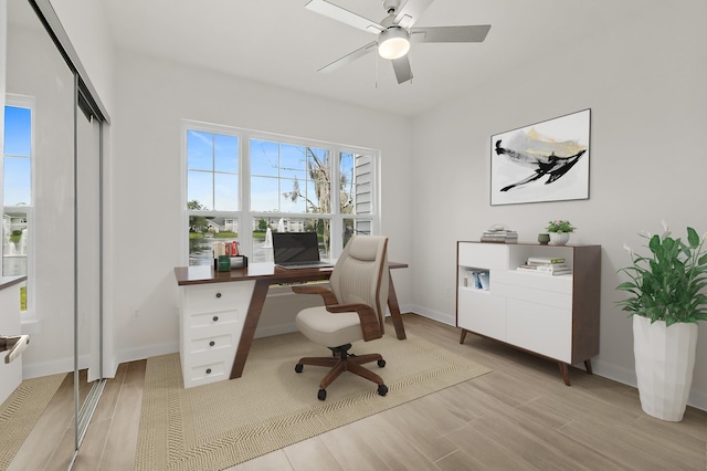 office area with light wood-type flooring and ceiling fan