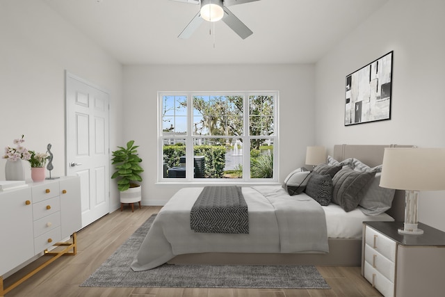 bedroom with ceiling fan and light hardwood / wood-style flooring