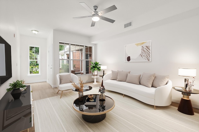 living room with ceiling fan and light hardwood / wood-style flooring