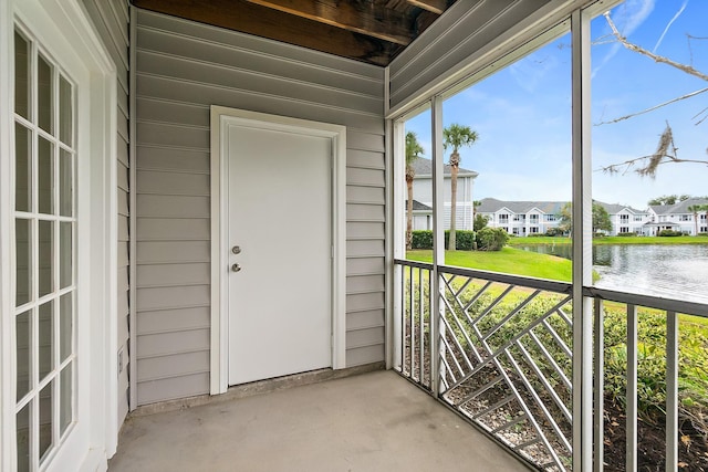 unfurnished sunroom with a water view