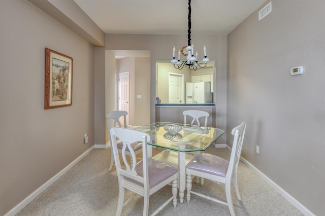 2202 Vista Cove Rd, Saint Augustine, FL 32084 - dining area featuring a chandelier, carpet, and baseboards
